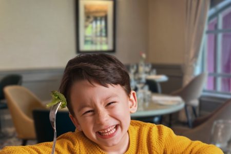 Young boy eating broccoli in The Kingsmills restaurant