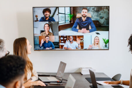 Team meeting with remote participants on a screen