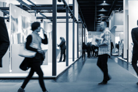 Trade show attendees walking around the stands