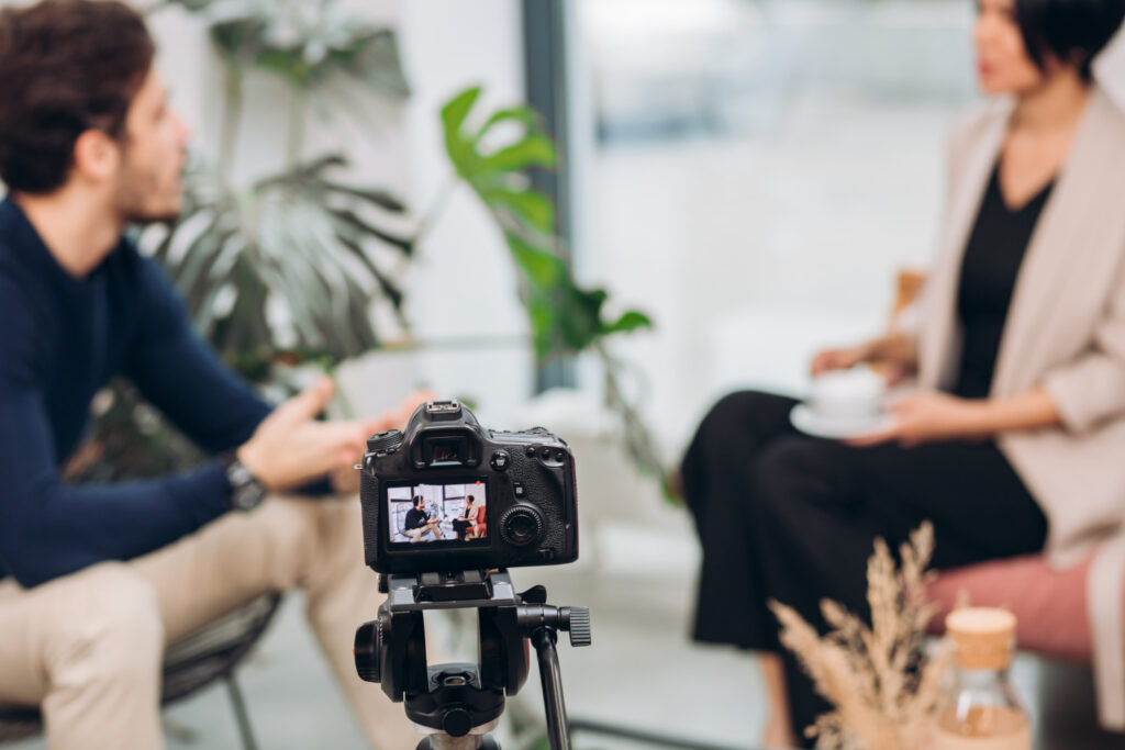 Two people talking in front of a camera